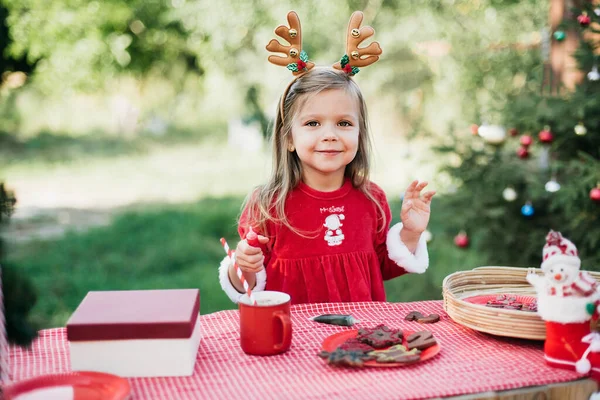 7月のクリスマス 子供は7月に木でクリスマスを待っています ホットココアをマシュマロとジンジャーで飲む女の子の肖像パン男のクッキー メリークリスマスとハッピーホリデー — ストック写真