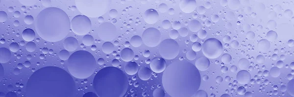 oil with bubbles on Violet background. Abstract space purple violet background. Soft selective focus. macro of oil drops on water surface. copy space. air bubbles in water. Trendy Color of Year 2022