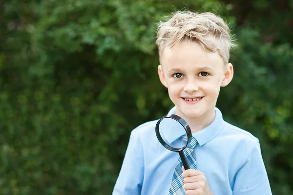Portrait Schoolboy Looking Magnifying Glass Background Autumn Park Farewell Bell — Stockfoto