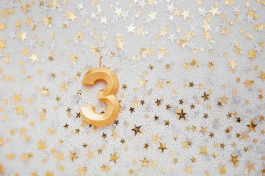 Number 3 three golden celebration birthday candle on Festive Background. three years birthday. concept of celebrating birthday, anniversary, important date, holiday