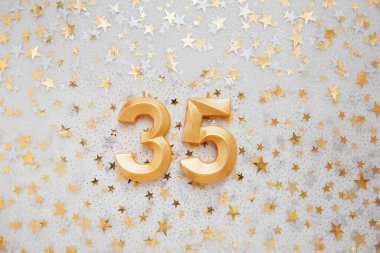Number 35 thirty five golden celebration birthday candle on Festive Background. thirty five years birthday. concept of celebrating birthday, anniversary, important date, holiday