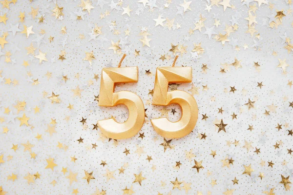 Number 55 fifty five golden celebration birthday candle on Festive Background. fifty five years birthday. concept of celebrating birthday, anniversary, important date, holiday