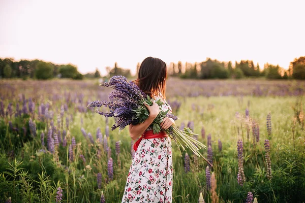 Beautiful Young Woman Holding Lupine Flowers Sunset Field Concept Nature — Stok Foto