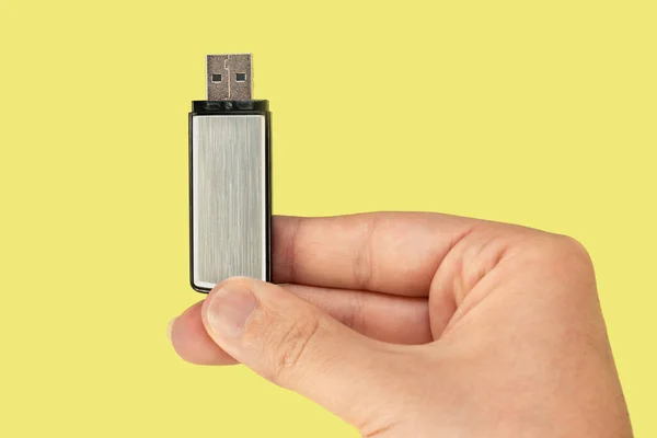 Metal Flash Drive Hand Isolated Yellow Background Front View — Stock Photo, Image