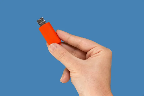 Orange Usb Flash Memory Hand Isolated Blue Background Front View — Stok fotoğraf