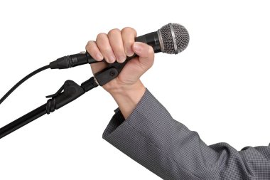 Professional singer with a grey checked jacket on an isolated white background. Highlights the hand and microphone