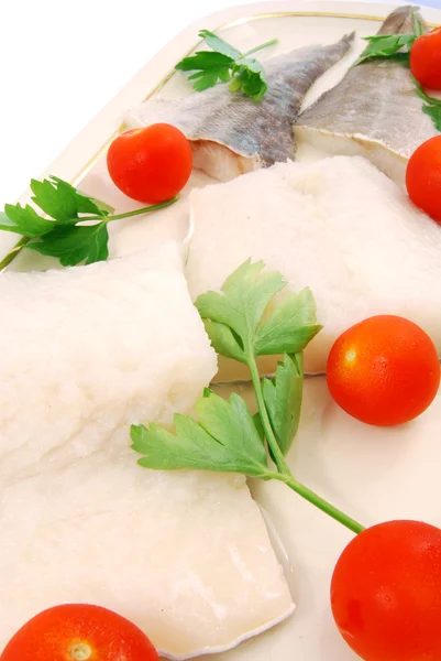 Pieces of cod with tomatoes and parsley — Stock Photo, Image