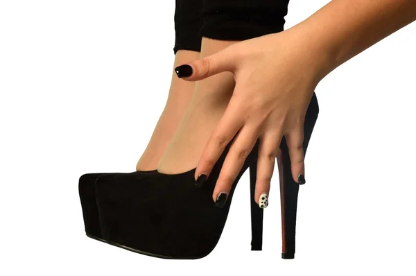 The hands of a woman on the shoes with high heels — Stock Photo, Image