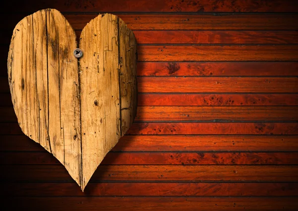 Houten hart op bruin hout achtergrond — Stockfoto