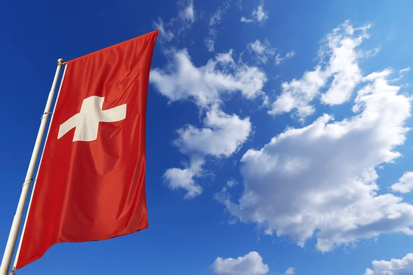Vlajka Švýcarska v modré obloze — Stock fotografie