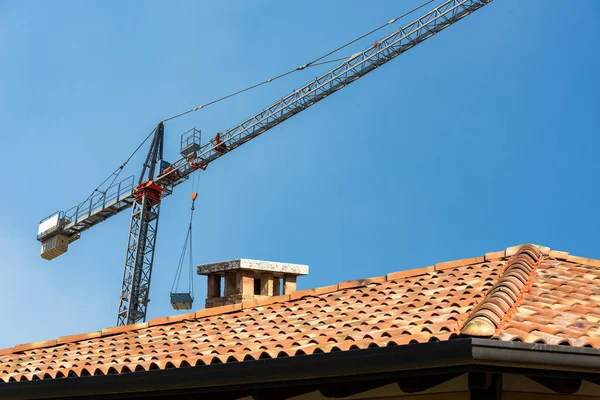 Baustelle Mit Turmdrehkran Und Einer Großaufnahme Eines Daches Mit Terrakottafliesen — Stockfoto