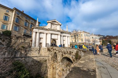 BERGAMO, ITALY - JAN 6, 2022: Ancient Gate of San Giacomo (St. James), 1592, and the surrounding walls (1561). Bergamo upper town with the bas relief of the Winged Lion of Saint Mark, Lombardy, Italy.