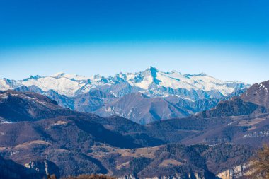 Adige Vadisi 'ndeki Monte Baldo Dağı (Baldo Dağı) ve Adamello Brenta Ulusal Parkı' nda Lessinia Platosu 'ndan görünen Care Alto zirvesi. Veneto ve Trentino Alto Adige, İtalya.