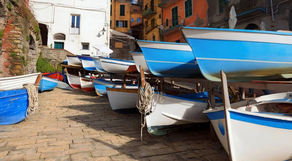 Large group of small wooden boats moored in the famous Riomaggiore village, Cinque Terre National Park in Liguria, La Spezia, Italy, Europe. UNESCO world heritage site.