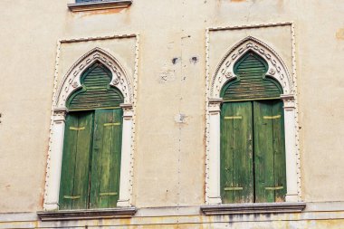 Venedik Gotik tarzında kemerli iki antik pencerenin yakın çekimi, küçük bir kasaba olan Oderzo, Treviso, Veneto, İtalya, Avrupa.