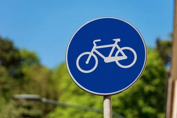 Close-up of a blue road sign of a cycle path in the center of an Italian city. Italy, Europe. Photography