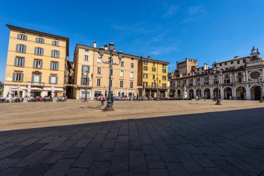 BRESCIA, ITALY - APRIL 17, 2022: Brescia downtown. The Loggia town square in Brescia downtown (Piazza della Loggia) with the clock and bell tower in Renaissance style, 1540-1550, Lombardy, Italy, Europe.