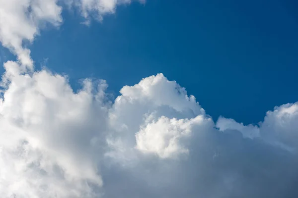 Beautiful storm clouds, cumulus clouds or cumulonimbus against a clear blue sky. Photography, full frame, sky only.