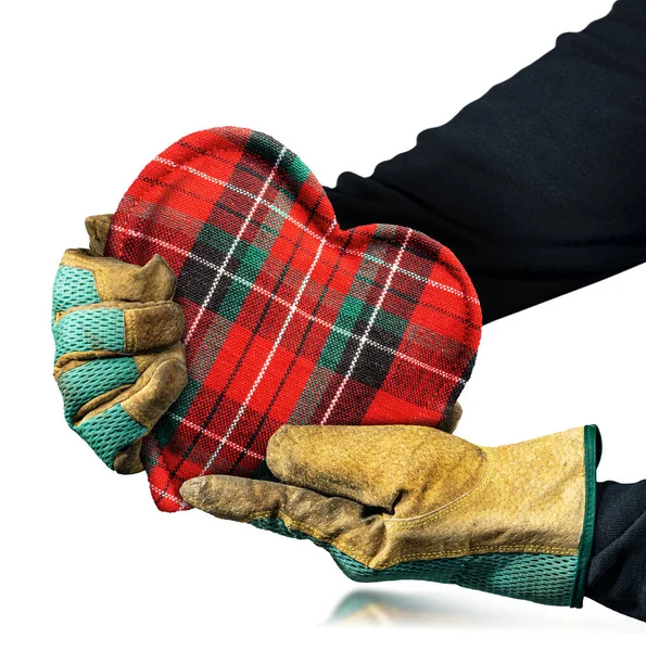 Manual worker with protective work gloves holding a fabric heart shape, isolated on white background.