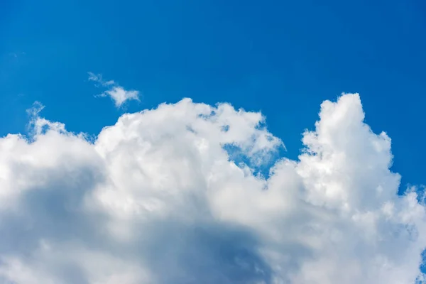 Beautiful storm clouds, cumulus clouds or cumulonimbus against a clear blue sky. Photography, full frame, sky only.