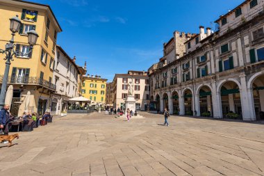 BRESCIA, ITALY - APRIL 17, 2022: Brescia downtown. Old town square called Piazza della Loggia of the Renaissance period with the marble statue of beauty Italy (Bella Italia), Lombardy, Italy, Europe.