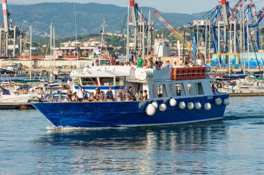 PORT OF LA SPEZIA, ITALY - JULY 28, 2022: tourist ferry boat to the Cinque Terre arriving in the port of La Spezia, tourist resort on the coast of the Gulf of La Spezia, Liguria, Italy, Europe.