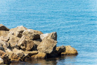 Close-up of a breakwater or groyne made of giant boulders by the sea, Port of the small and ancient Tellaro village, Lerici municipality, Gulf of La Spezia, Liguria, Italy, southern Europe.