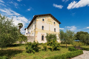 Ancient frescoed town hall building in the small town of Spilimbergo (Palazzo di Sopra), XIV century, with the Winged Lion of Saint Mark. Pordenone province, Friuli-Venezia Giulia, Italy, Europe.