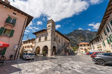 VENZONE, ITALY - AUGUST 11, 2022: Ancient town hall and square in Venzone, partially destroyed by the 1976 earthquake and rebuilt between 1979 and 1984. Udine, Friuli-Venezia Giulia, Italy, Europe.