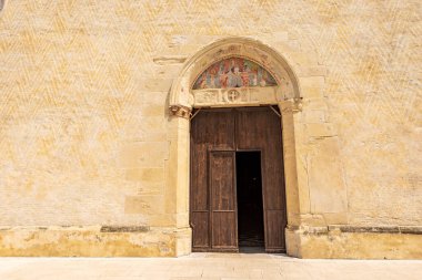 Main facade of the medieval Cathedral of Santa Maria Maggiore in Romanesque Gothic style, 1284-1359. Spilimbergo town, Pordenone province, Friuli-Venezia Giulia, Italy, Europe.