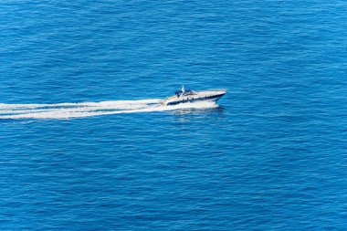 Aerial view of a luxury speedboat or yacht in motion in the blue Mediterranean sea. Gulf of La Spezia, Liguria, Italy, Europe.
