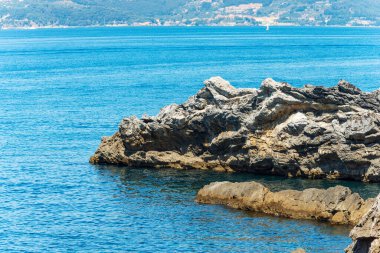 Cliffs and Mediterranean Sea at summer. Gulf of La Spezia or Gulf of Poets, Tellaro village, Lerici municipality, Liguria, Italy, Europe.