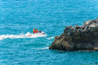 LA SPEZIA, ITALY - JULY 24, 2022: Patrol of Italian lifeguards of firefighters (Vigili del Fuoco) aboard of a jet ski in the Mediterranean Sea, Gulf of La Spezia, Liguria, Italy, Europe. 