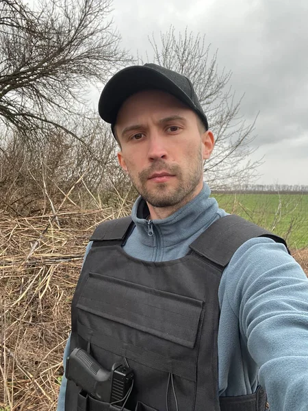 Portrait Young Man Uniform Cap Handgun Bulletproof Vest Background Field — Stock Photo, Image