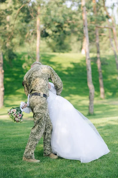 Bride White Dress Groom Military Uniform Kiss Embrace Walking Forest — Photo