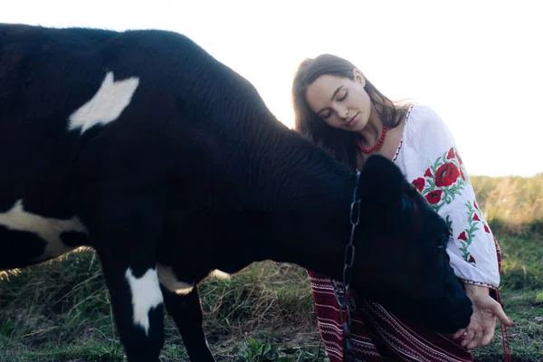 Young Ukrainian Woman Sits Touches Calf Dressed Traditional National Embroidered — 스톡 사진