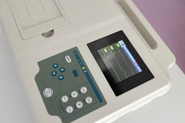 Electrocardiography procedure using cardiograph in modern clinic. Test, professional consult, diagnostic, healthcare, medical service. Closeup. Top view.