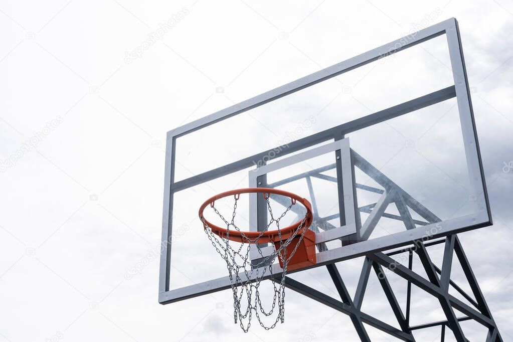 Basketball backboard with a ring, color photo processing. Black and white photo and ring highlighted in red. Focus on the basketball basket as a goal.