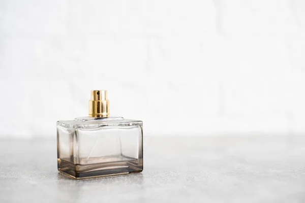 bottle of woman perfume on gray background, top view, flat lay. Mockup of gold fragrance perfume bottle mockup on empty background.