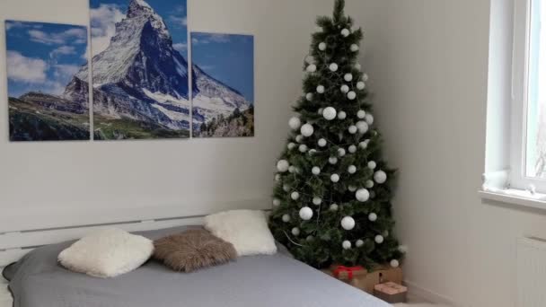 Stijlvol interieur met kerstboom en geschenkdozen. kerstboom in de slaapkamer — Stockvideo