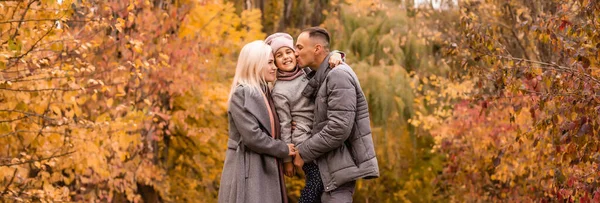 Eine vierköpfige Familie genießt goldenes Laub im Herbstpark — Stockfoto