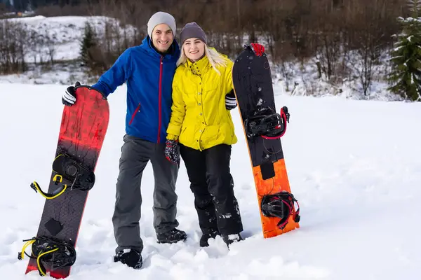 Портрет счастливой пары сноубордистов на улице во время зимних каникул — стоковое фото