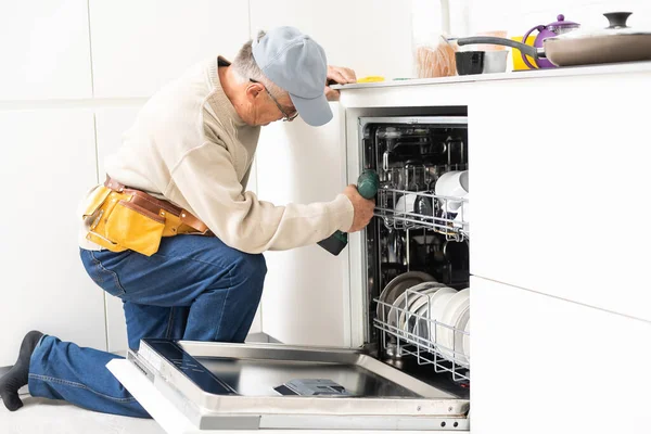 Techniker oder Klempner Mann repariert Geschirrspüler — Stockfoto