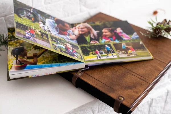 Photo book with wooden cover. unfolded photobook. sample photobook. — Stock Photo, Image