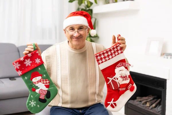 Old age, holidays, problem and people concept - senior man in glasses thinking at home over christmas tree background — Stock Photo, Image