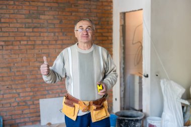 İnşaat alanında mezuralı yaşlı işçi