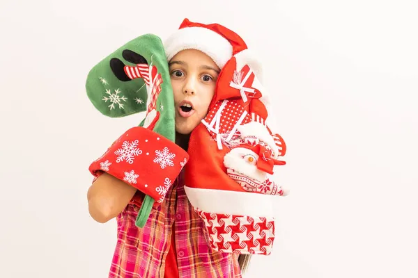 Portrait of a laughing little girl holding Christmas decoration in hands on white background — Stock Photo, Image