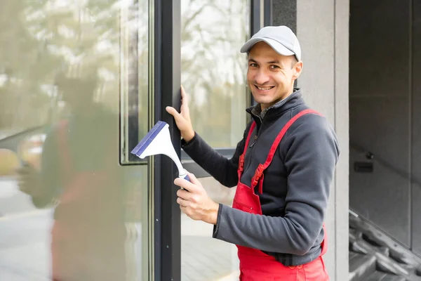 Professional cleaning, man washes window — Stock Photo, Image