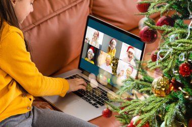 Çekici mutlu genç kız öğrenci görüntülü konuşma yapıyor, el sallıyor. Noel.
