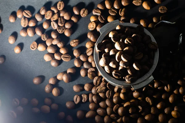 Coffee beans in the coffee machine horn. Postcard for cafes and restaurants. Close up. — Stock Photo, Image